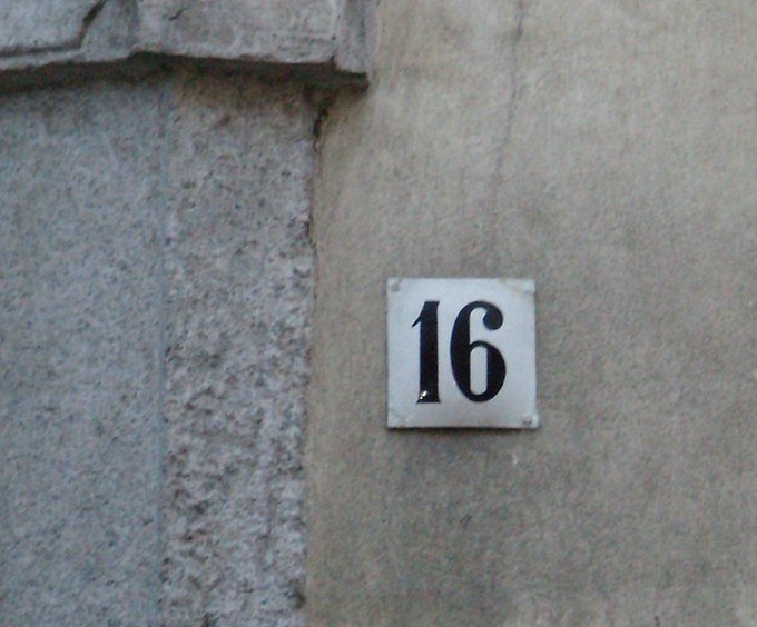 This photo shows the number 16 written in black.