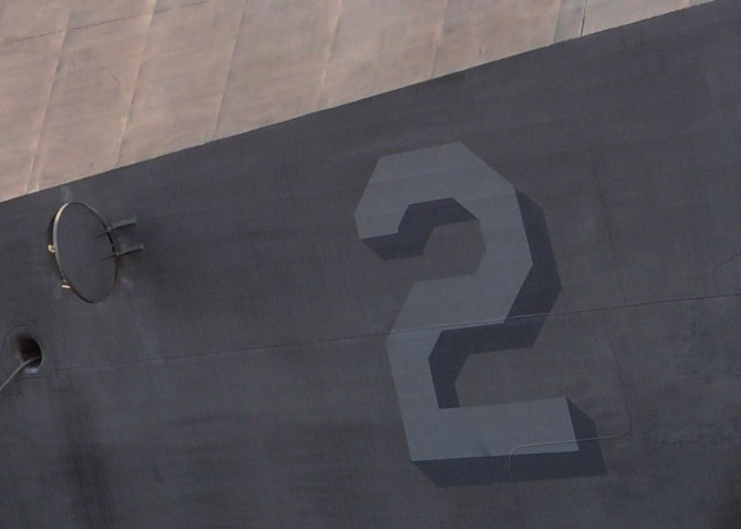 This photo shows the number 2 written on the side of a large ship.