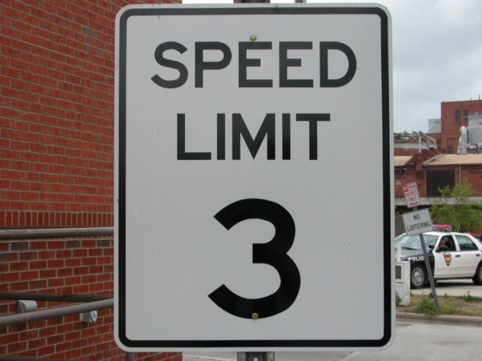 This photo shows the number 3 written on a speed limit sign.