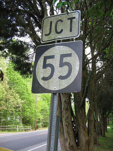 This photo shows the number 55 on a road sign.