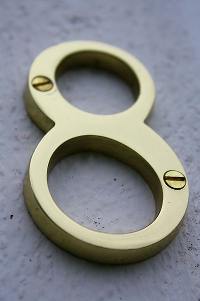 This photo shows a metallic number 8 used to indicate the street address of a house.